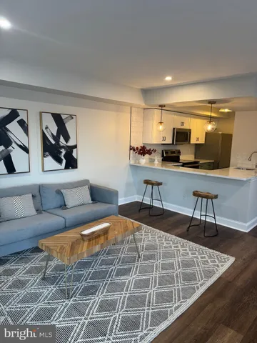 a living room with furniture a rug and a table