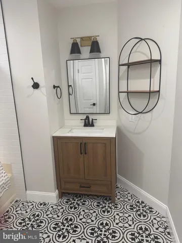 a bathroom with a sink a toilet and a mirror