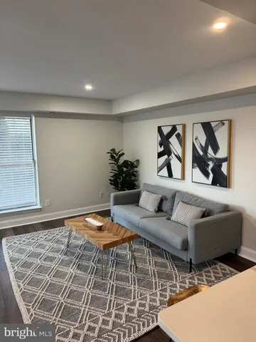 a living room with furniture and a rug