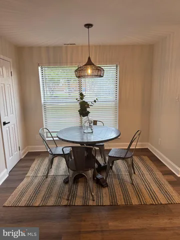 a dining room with furniture and wooden floor