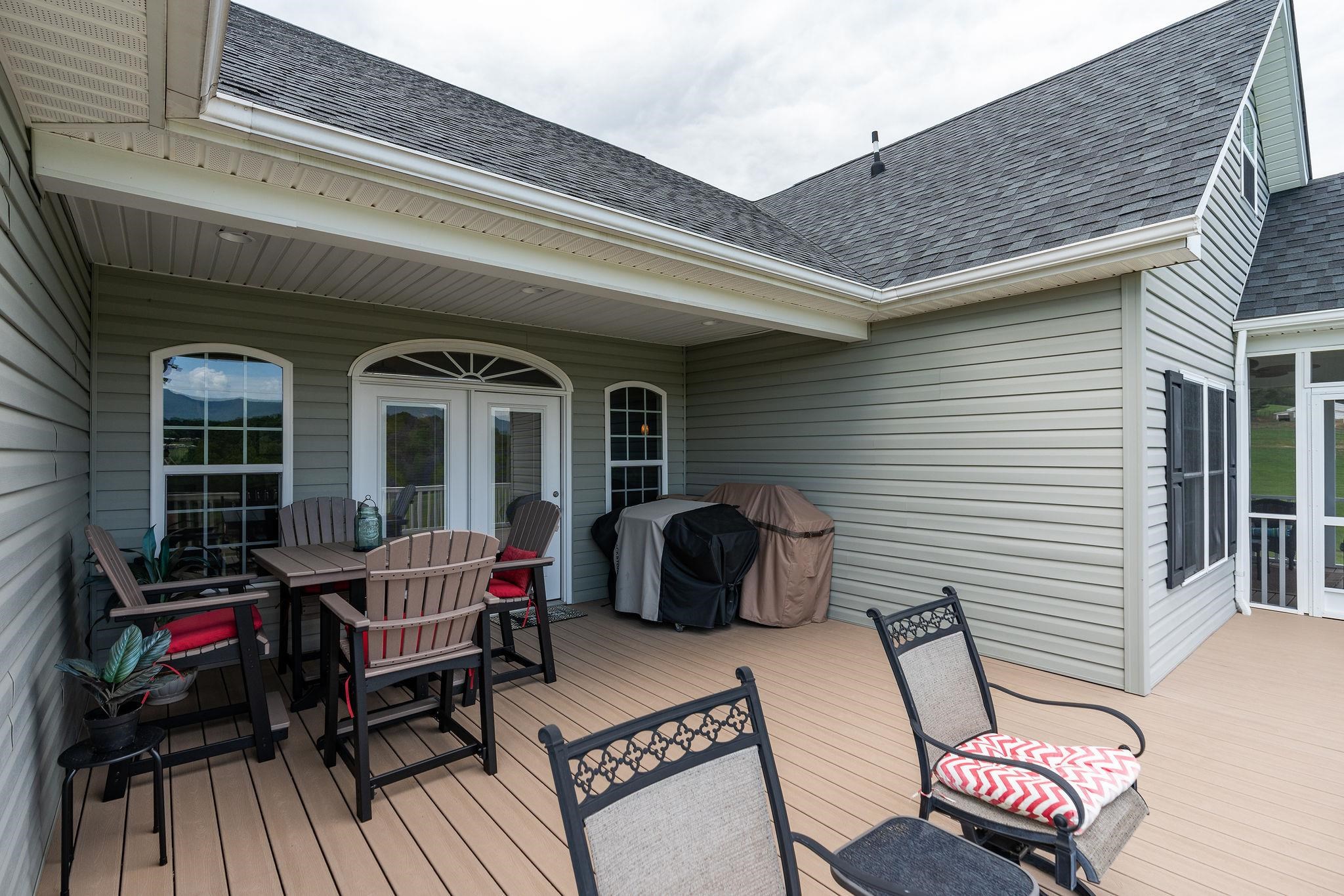 65 Indian Ridge Road Greenville, VA 24440 - Photo 54 of 75 a view of a patio with table and chairs with wooden floor and fence