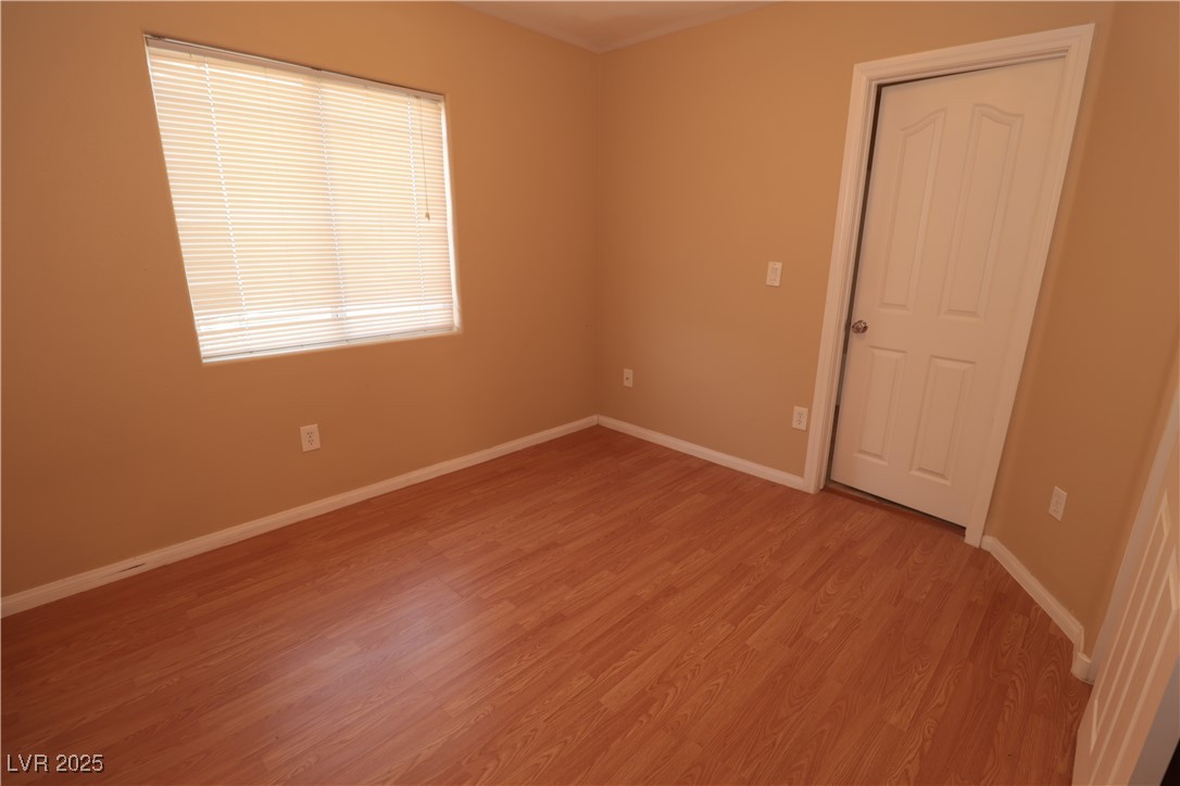 5940 Feral Garden Street North Las Vegas, NV 89031 - Photo 9 of 31 Spare room featuring light wood-style floors and baseboards