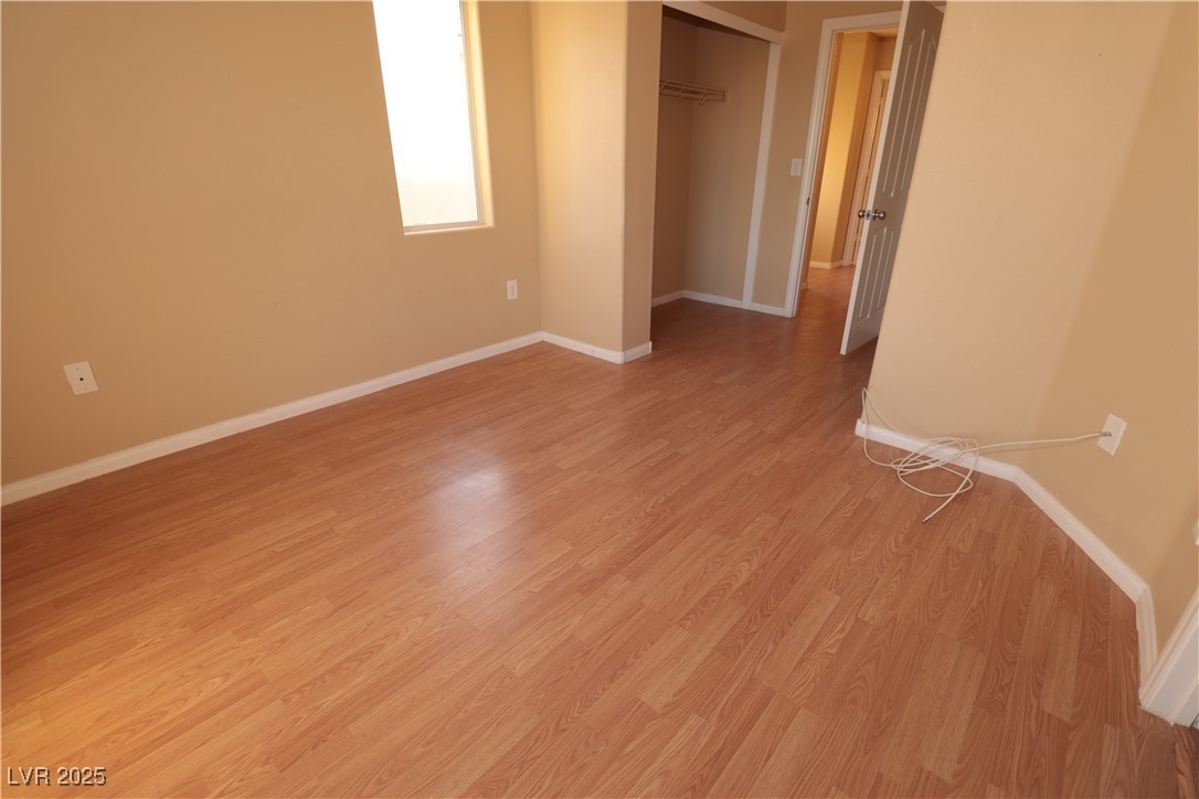 5940 Feral Garden Street North Las Vegas, NV 89031 - Photo 14 of 31 Unfurnished bedroom with light wood-style flooring and a closet