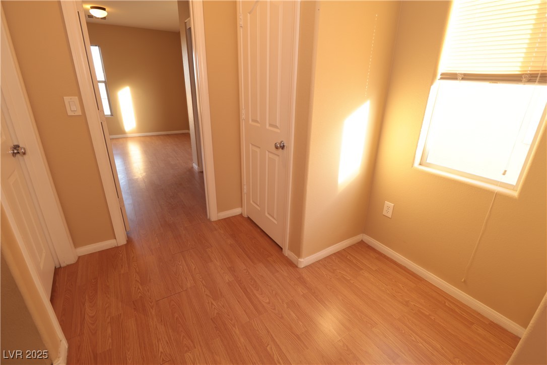 5940 Feral Garden Street North Las Vegas, NV 89031 - Photo 17 of 31 Hallway with light wood-style floors and baseboards