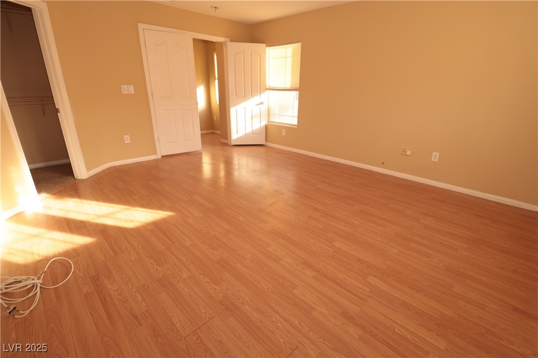 5940 Feral Garden Street North Las Vegas, NV 89031 - Photo 19 of 31 Unfurnished bedroom featuring light wood-style flooring and a spacious closet