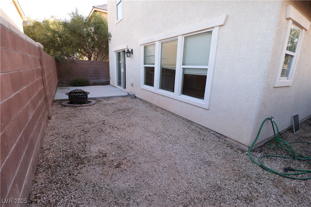 5940 Feral Garden Street North Las Vegas, NV 89031 - Photo 26 of 31 View of yard with a fire pit and a patio