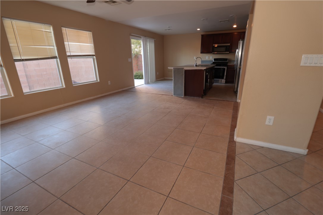 5940 Feral Garden Street North Las Vegas, NV 89031 - Photo 4 of 31 Unfurnished living room featuring light tile patterned floors and recessed lighting