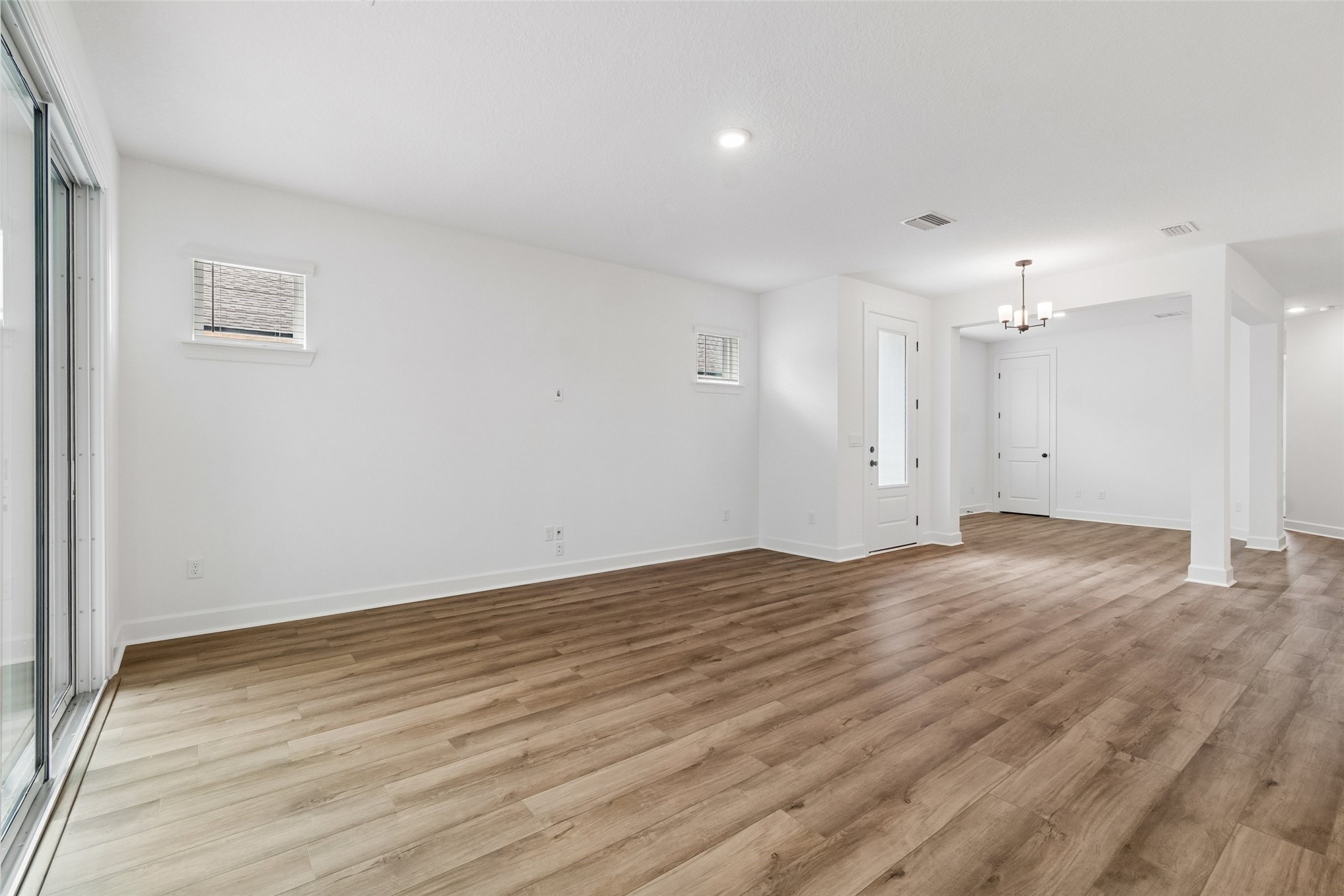 718 Windchime Street Yulee, FL 32097 - Photo 11 of 28 a view of an empty room with wooden floor