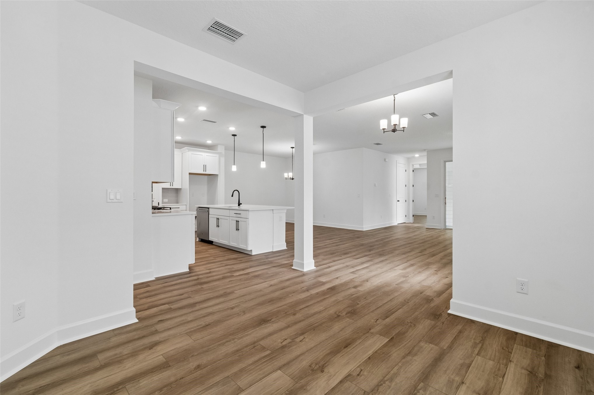 718 Windchime Street Yulee, FL 32097 - Photo 14 of 28 a view of a kitchen with wooden floor and windows