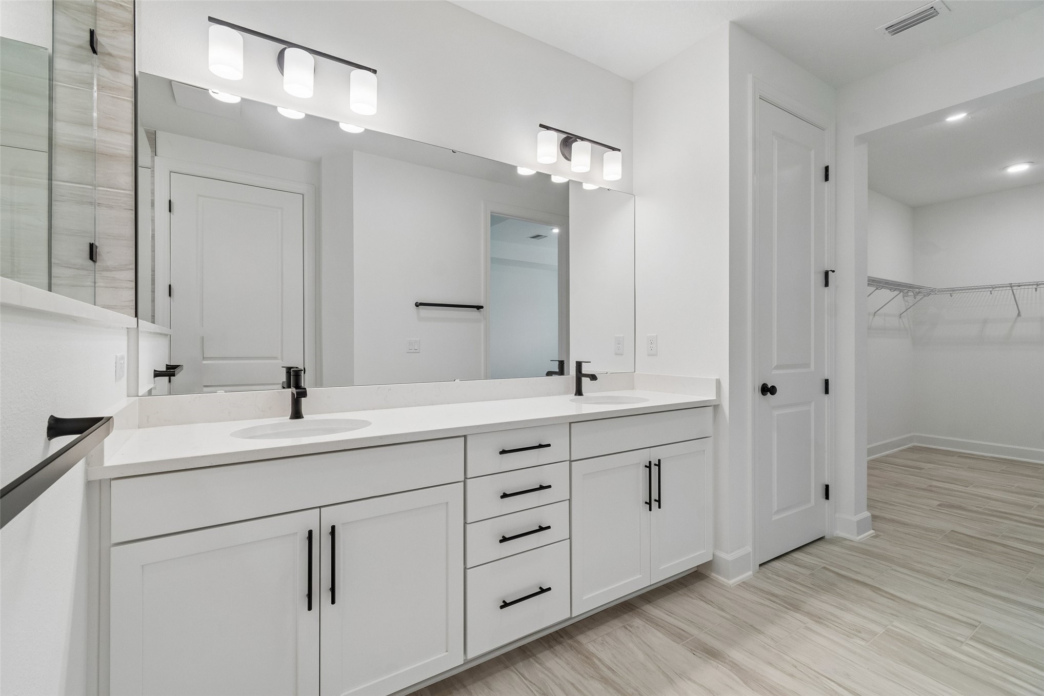 718 Windchime Street Yulee, FL 32097 - Photo 23 of 28 a bathroom with double vanity sinks and a mirror