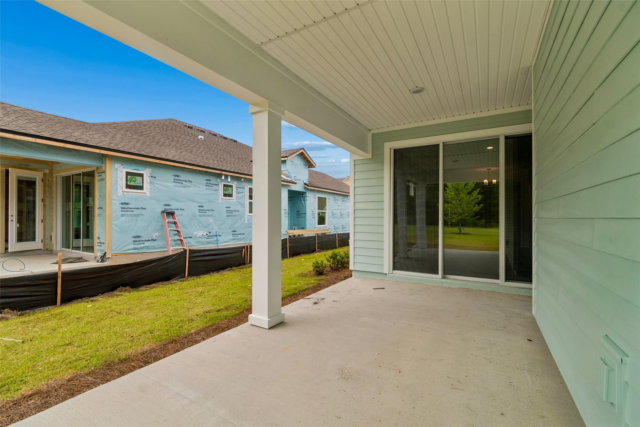 718 Windchime Street Yulee, FL 32097 - Photo 27 of 28 a view of an house with backyard porch and furniture