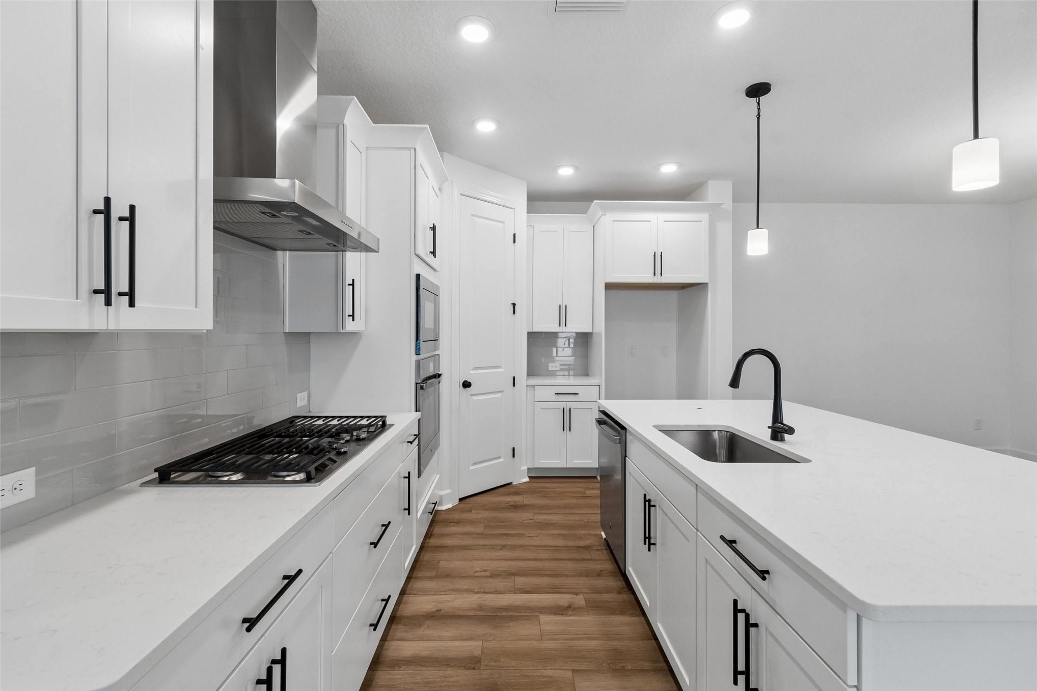 718 Windchime Street Yulee, FL 32097 - Photo 6 of 28 a kitchen with stainless steel appliances a sink stove and cabinets