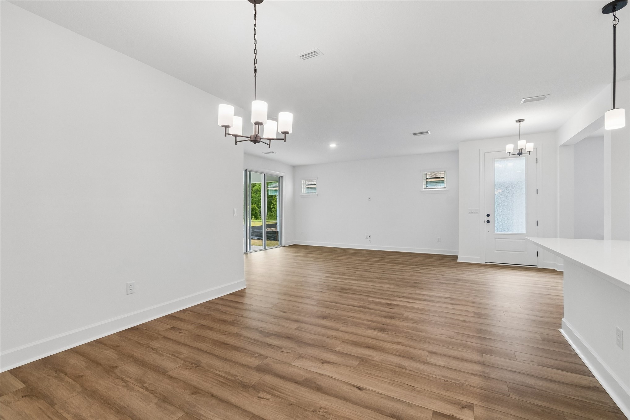 718 Windchime Street Yulee, FL 32097 - Photo 10 of 28 a view of a room with wooden floor and windows