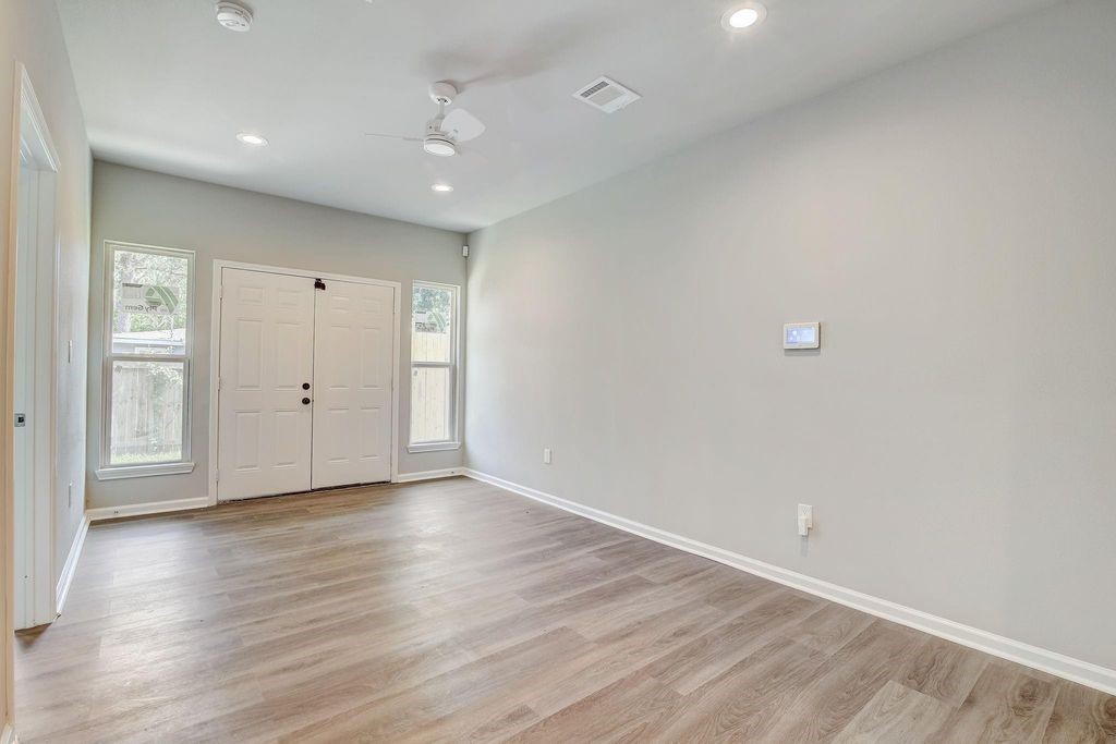 5338 Rapido Road Houston, TX 77033 - Photo 4 of 9 a view of an empty room with wooden floor