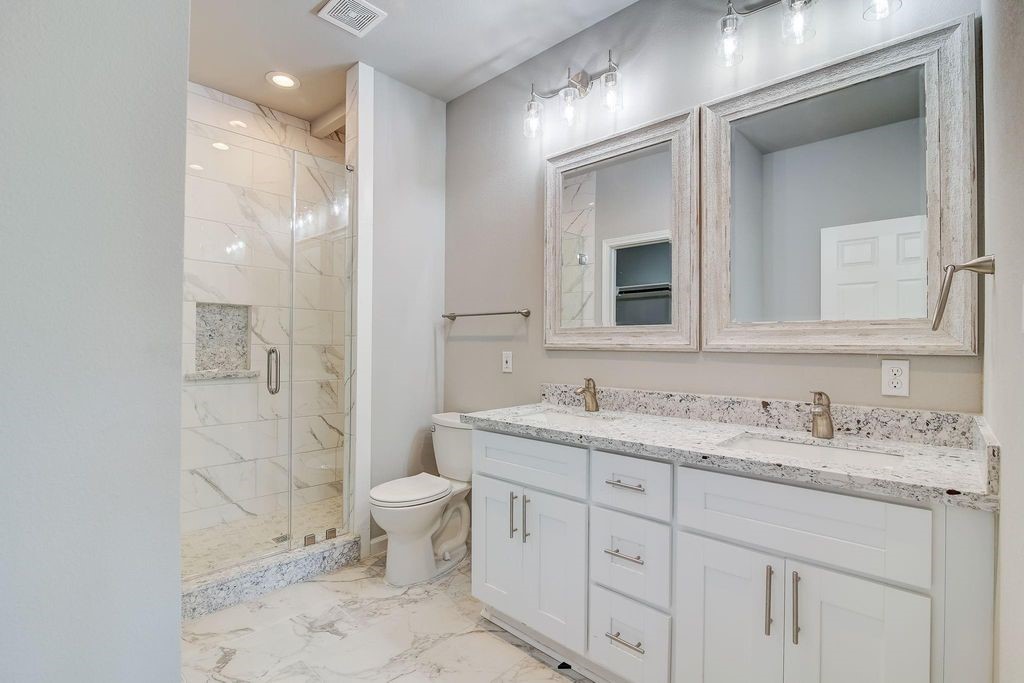 5338 Rapido Road Houston, TX 77033 - Photo 6 of 9 a bathroom with a toilet sink and mirror