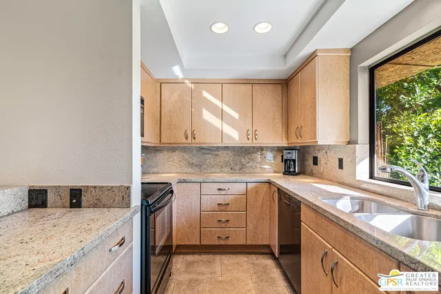 a kitchen with a sink stove and cabinets