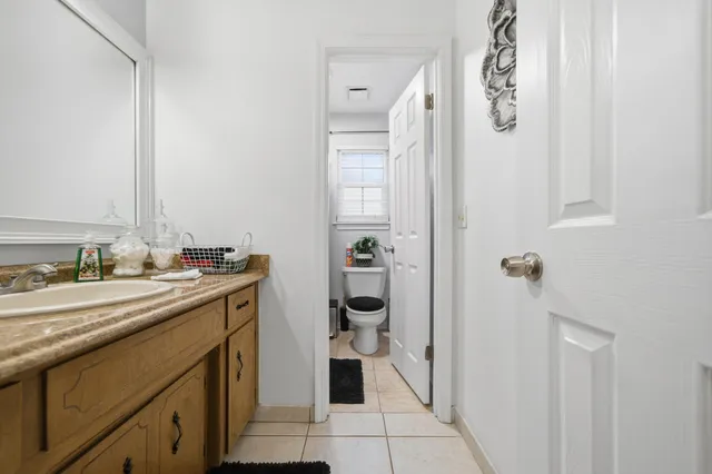 a spacious bathroom with a sink and mirror