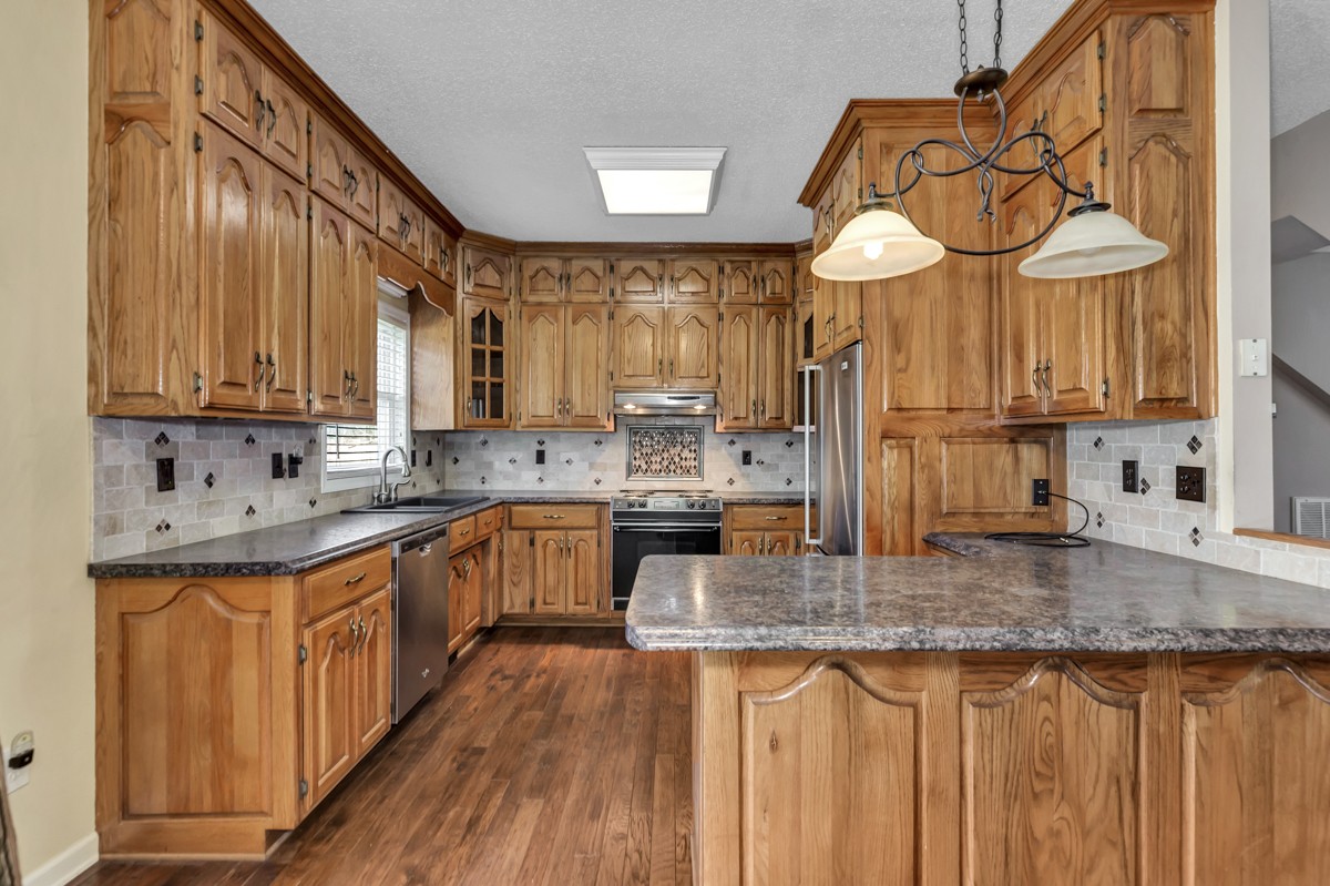 673 Molino Road Fayetteville, TN 37334 - Photo 8 of 31 a kitchen with stainless steel appliances granite countertop a sink a stove cabinets and wooden floor