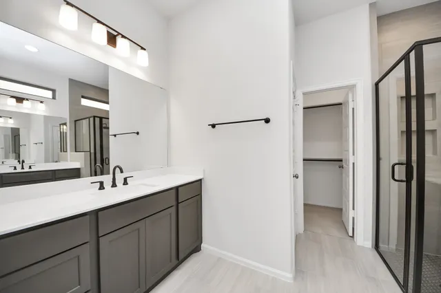 a bathroom with a double vanity sink and mirror