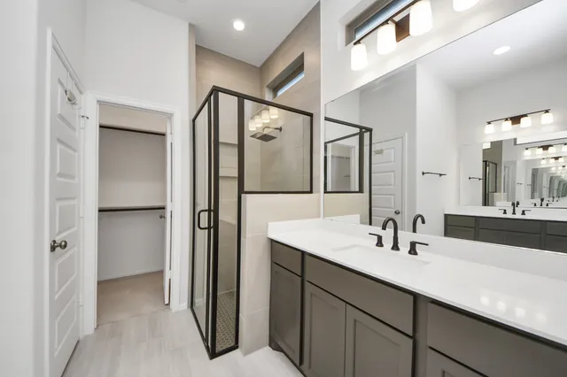 a bathroom with a double vanity sink and mirror