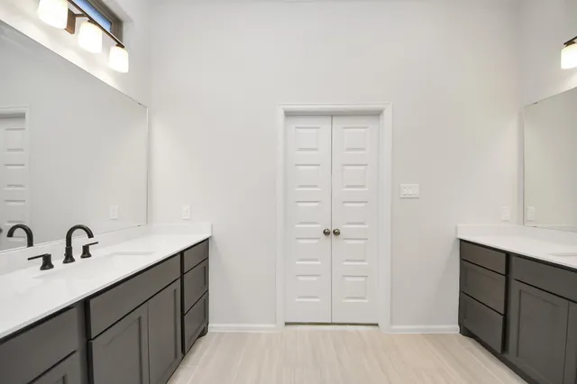 a bathroom with a sink a vanity and a mirror