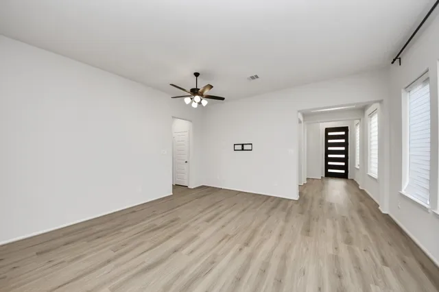wooden floor in an empty room with a window