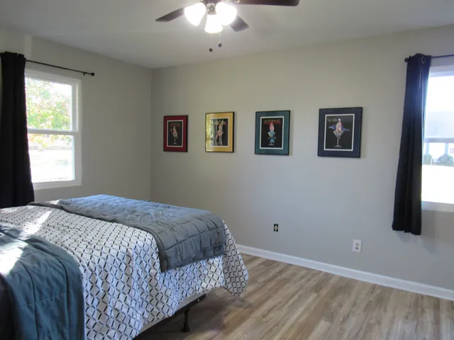 a bedroom with a bed and a window