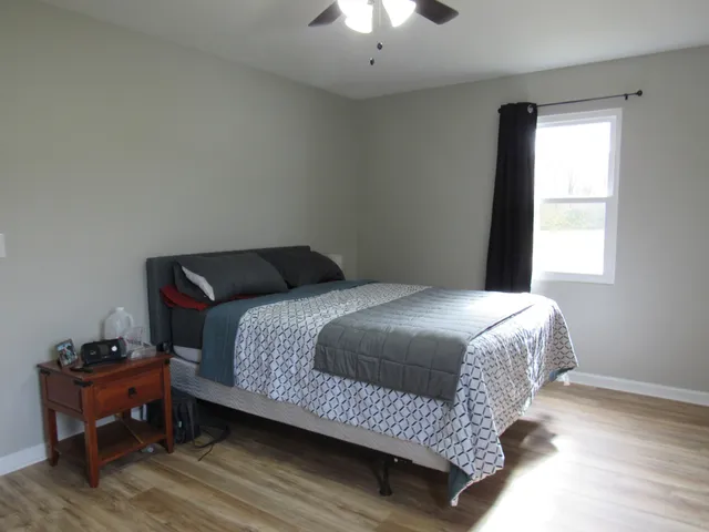 a bedroom with a bed and a window