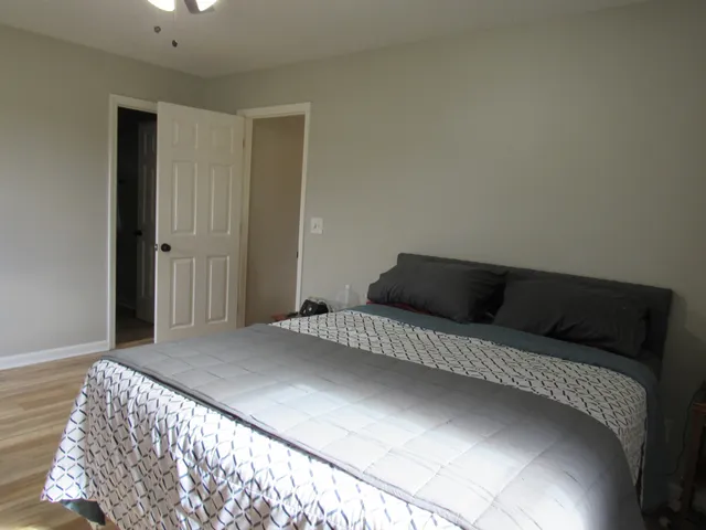 a bedroom with a bed and a night stand