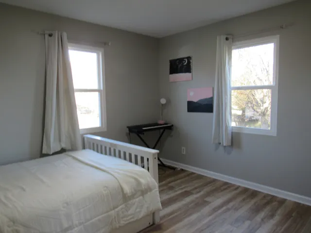 a bedroom with a bed and a window