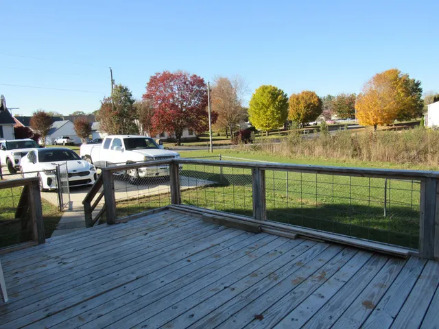 a view of a terrace with wooden floor and lake view