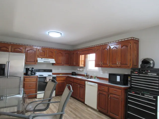 a kitchen with a sink cabinets and window