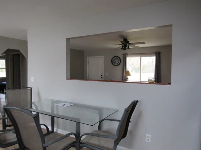 a living room with a couch and a ceiling fan