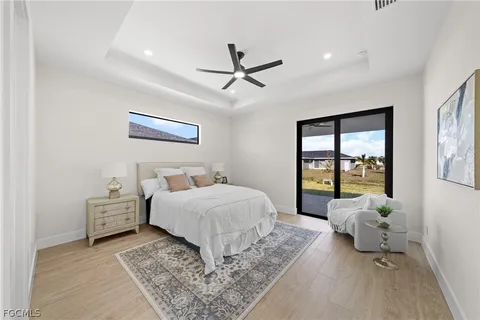 a spacious bedroom with a bed and glass walk in closet