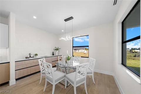 a view of a dining room with furniture and wooden floor