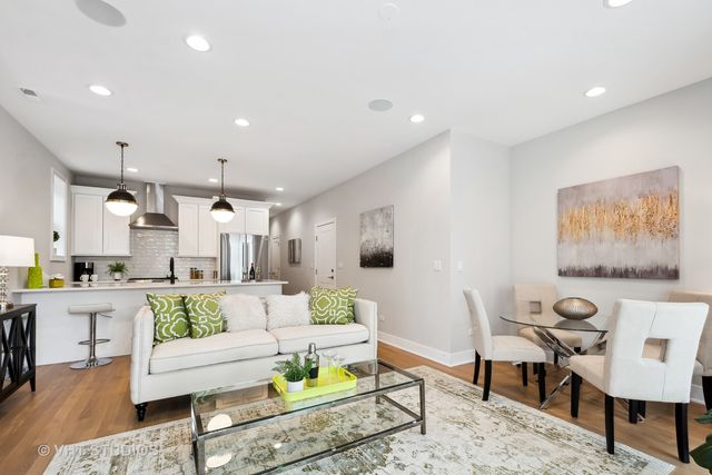 a living room with fireplace furniture and a rug