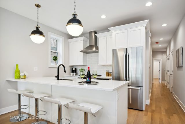a kitchen with stainless steel appliances a sink a counter space and refrigerator