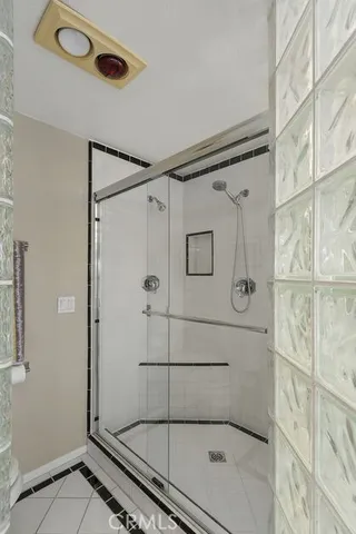 a bathroom with a glass shower door