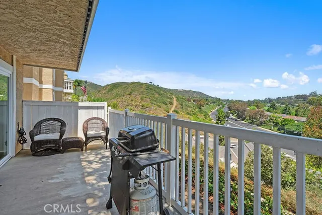 a view of a balcony with mountain view and a floor to ceiling window