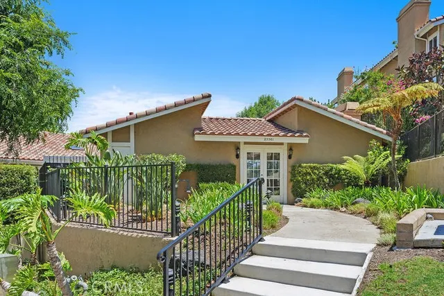 a view of a house with a small yard and plants
