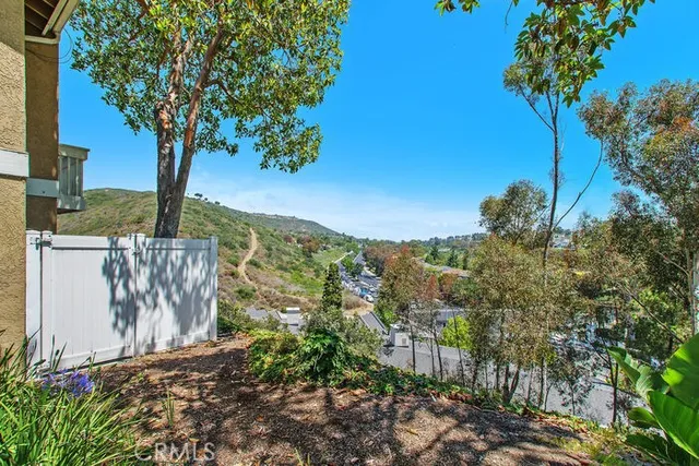 a view of a garden with large trees