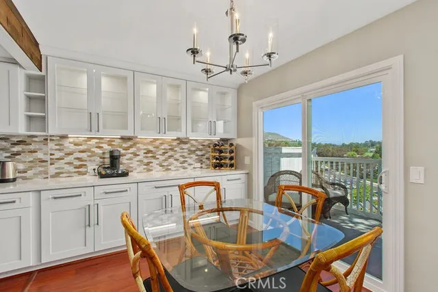 a dining table with chairs and window