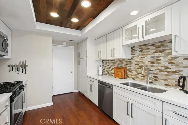 a kitchen with stainless steel appliances a sink a stove and a refrigerator