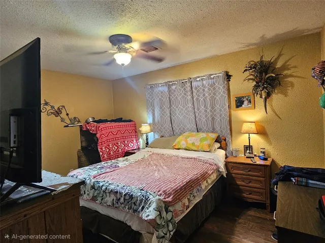 a bedroom with furniture and a flat screen tv
