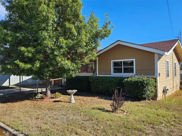 a backyard of a house with table and chairs