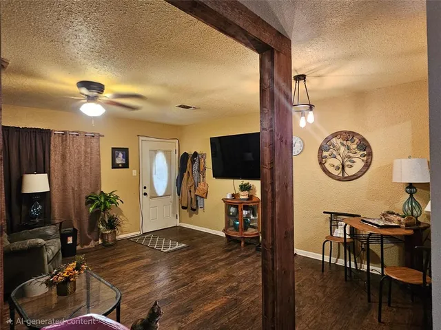 a view of a livingroom with furniture a flat screen tv and wooden floor
