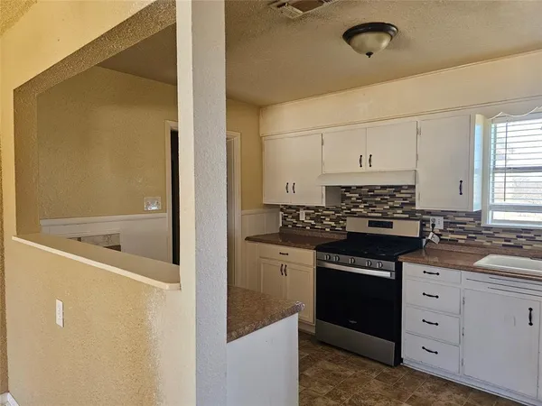 a kitchen with a sink and cabinets