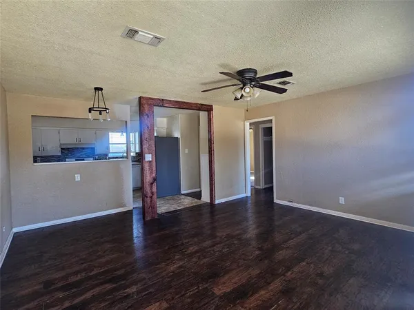 a view of a kitchen with a dishwasher and wooden floor