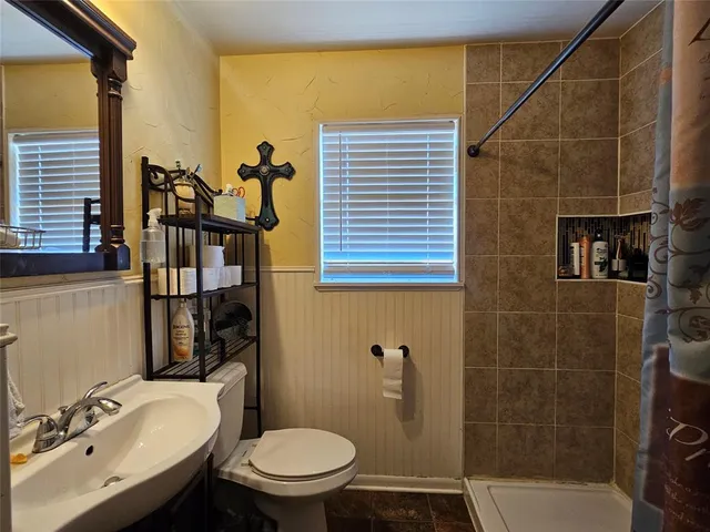 a bedroom with a bed dresser and a window