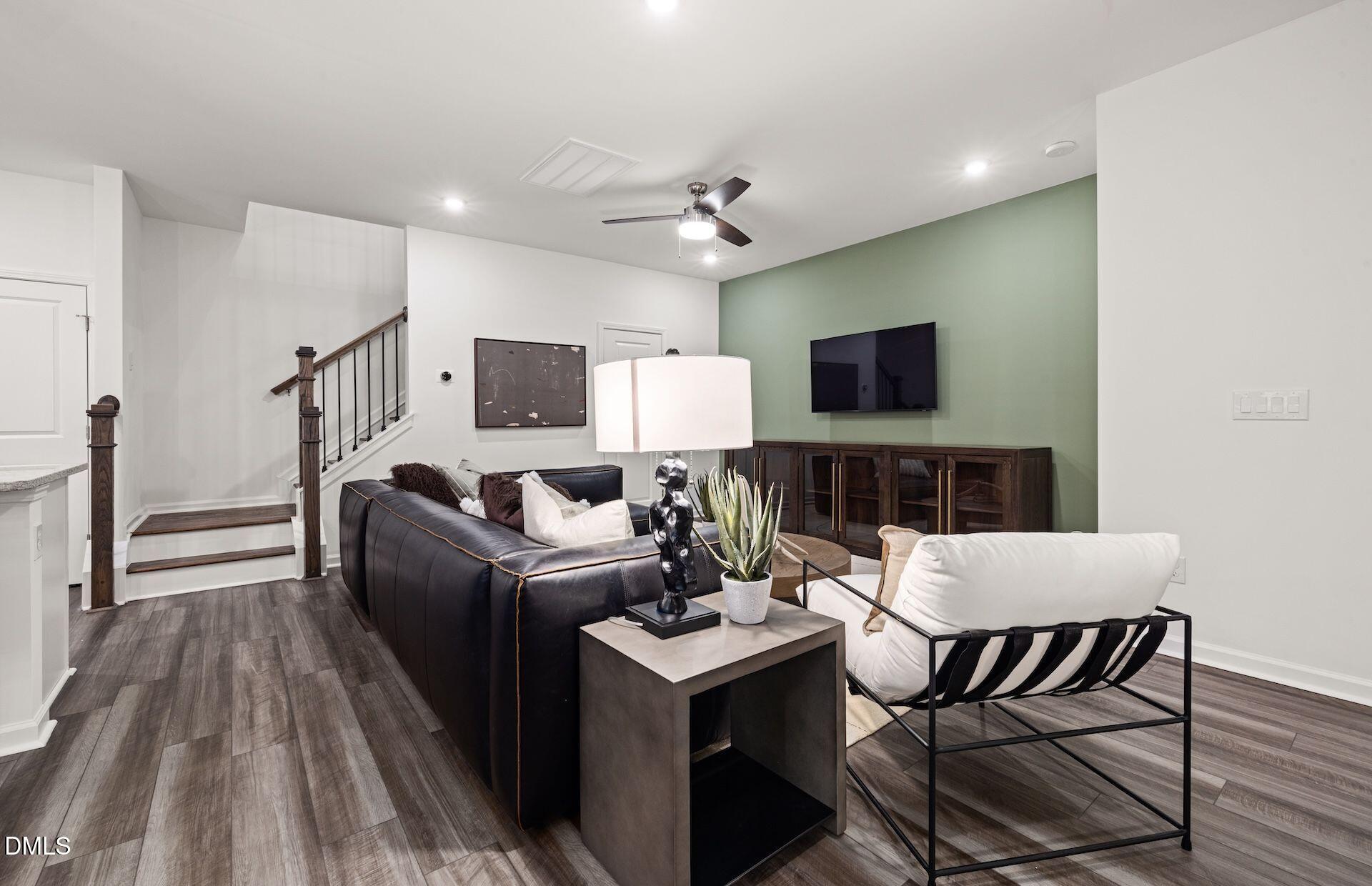 5021 Reader Way Durham, NC 27703 - Photo 7 of 32 a living room with furniture a flat screen tv and kitchen view